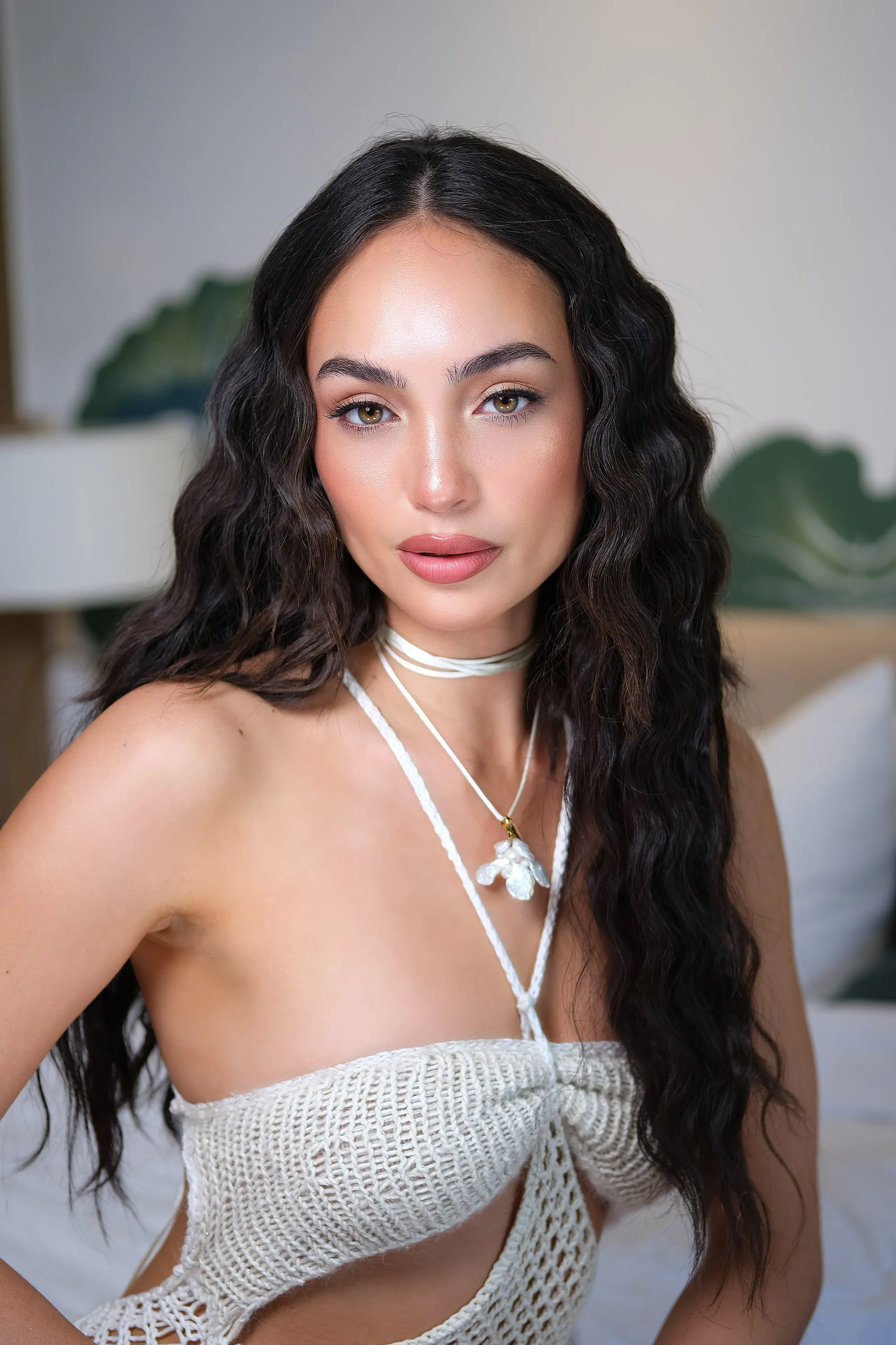 The same high-shine editorial look straight on, showing the softly blended shadow and the sculpted nose.